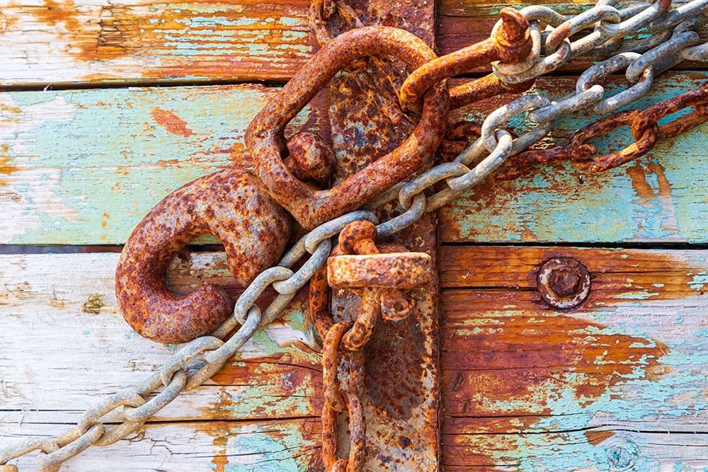 Rusty lock and chain on light blue wood